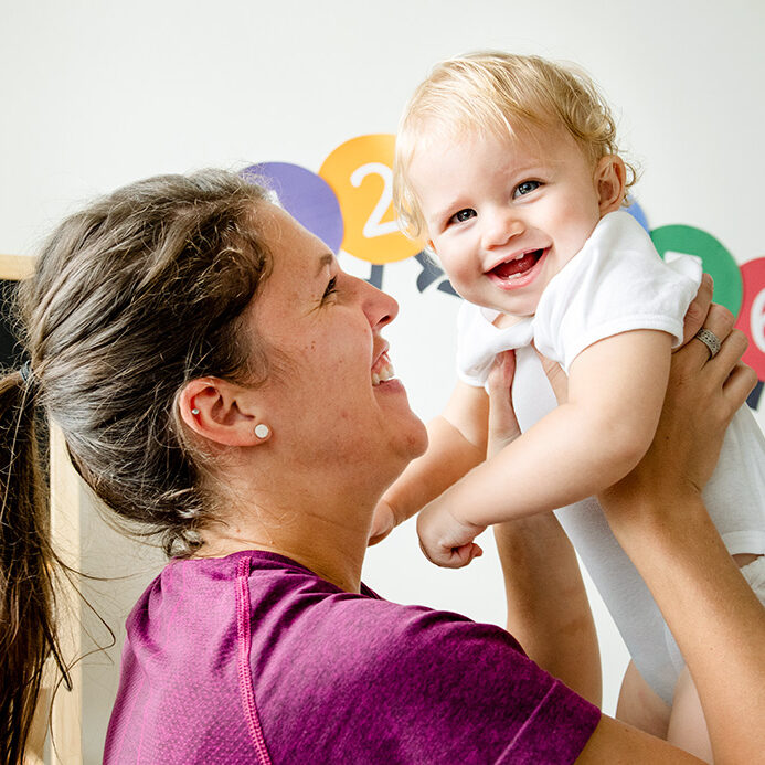 teacher-holding-smiling-infant